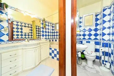 a blue and white bathroom with a sink and a toilet at Appartement chic de 2 chambres au coeur de casablanca in Casablanca