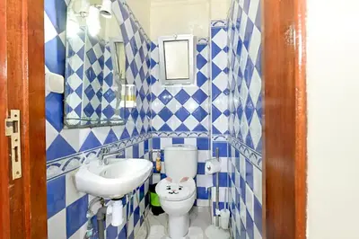 a blue and white bathroom with a toilet and a sink at Appartement chic de 2 chambres au coeur de casablanca in Casablanca