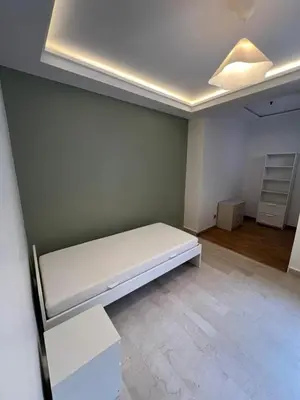 an empty room with a white bed in it at Appartement 2 chambres in Casablanca