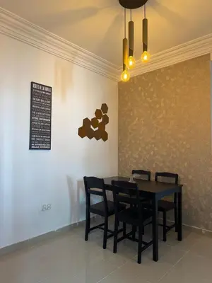 a dining room with a black table and chairs at Opposite Train Station & Tram Modern Quiet & Meals Available in Casablanca