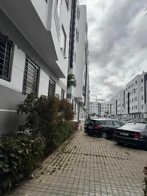 a street with cars parked next to a building at Opposite Train Station & Tram Modern Quiet & Meals Available in Casablanca