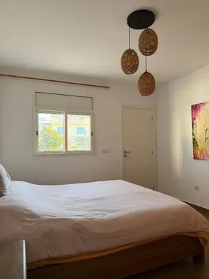 a bedroom with a white bed and a window at Villa front mer in Rabat