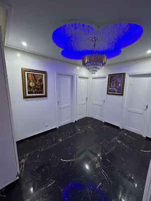 a large room with a blue ceiling and a chandelier at Appartement 5 pieces à casablanca in Casablanca