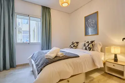 a bedroom with a large bed and a window at Sunny Spacious 3 BR Apartment CIL view in Casablanca