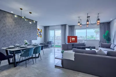 a living room with a couch and a table at Sunny Spacious 3 BR Apartment CIL view in Casablanca