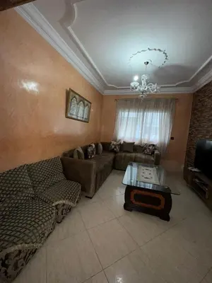 a living room with a couch and a table at Comfortable apartment, Stade in Rabat