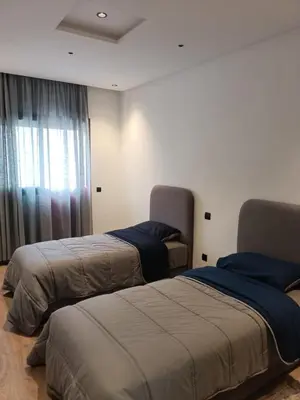 a room with two beds and a window at Appartement haut standing piscine et fitness in Mohammedia
