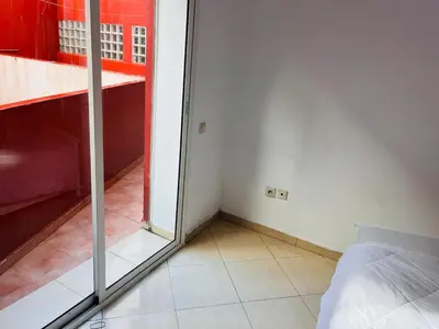 a room with a bed and a sliding glass door at 2 bedroom apartment with breakfast included in Casablanca
