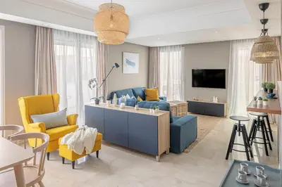 a living room with a blue couch and yellow chairs at CFC, cozy 2 bedrooms apartment living room in Casablanca