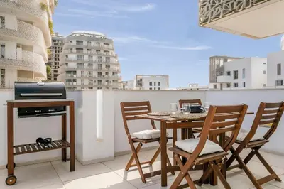 a patio with a table and chairs on a balcony at CFC, cozy 2 bedrooms apartment living room in Casablanca