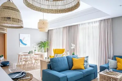 a living room with a blue couch and yellow pillows at CFC, cozy 2 bedrooms apartment living room in Casablanca