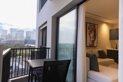 a balcony with a table and a couch at Premium Studio H&M - Near CFC and Anfa Park in Casablanca