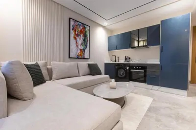 a living room with a couch and a table at Premium Studio H&M - Near CFC and Anfa Park in Casablanca