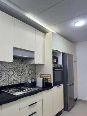 a kitchen with white cabinets and a stove top oven at Opposite Train Station & Tram Modern, Quiet & Meals Available in Casablanca