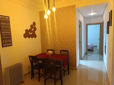 a dining room with a red table and chairs at Opposite Train Station & Tram Modern, Quiet & Meals Available in Casablanca