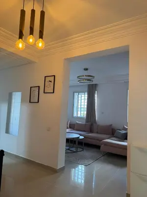 a living room with a couch and a table at Opposite Train Station & Tram Modern, Quiet & Meals Available in Casablanca