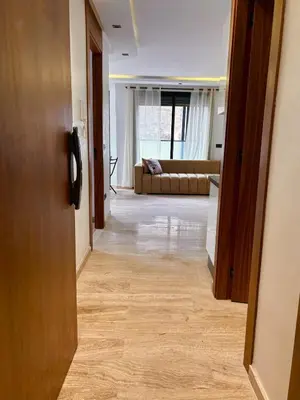 a hallway leading to a living room with a couch at Quiet, Sunny Studio 3 min CFC - Self-Check-In in Casablanca