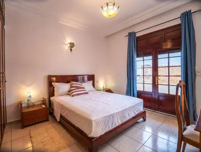 a bedroom with a bed and a window at Downtown Casablanca Living Terrace & Tram Access in Casablanca