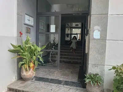 a woman is running down the stairs in a building at Face à la Gare et au Tramway Moderne, Calme avec Resto sur place possible in Casablanca