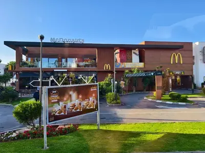 a mcdonalds restaurant with a sign in front of it at Face à la Gare et au Tramway Moderne, Calme avec Resto sur place possible in Casablanca