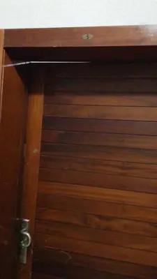 a wooden door of a wooden cabinet with a handle at Hébergement de lux près stades in Rabat