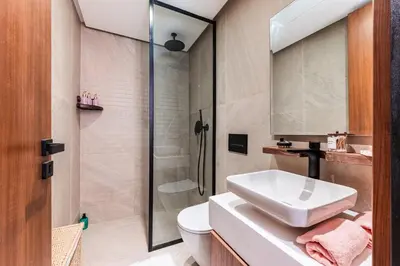 a bathroom with a sink and a toilet and a shower at Uptown Casa Anfa Luxury at Casa Finance City in Casablanca