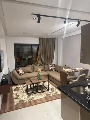 a living room with a couch and a table at Studio Zen in Maarif