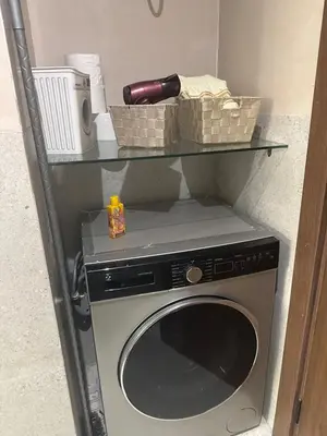 a washing machine with a shelf on top of it at Studio Zen in Maarif