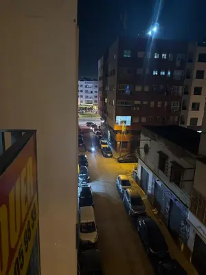 a view of a city street at night with cars parked at Studio Zen in Maarif