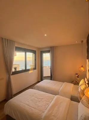 a bedroom with two beds and a window at Epic Oceanfront Flat - 360 Sea View in Casablanca