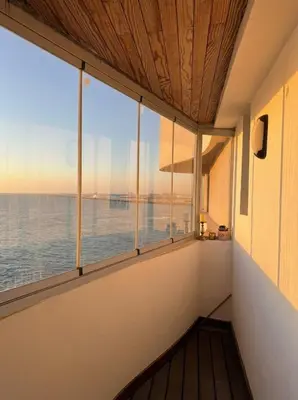 a room with a window with a view of the ocean at Epic Oceanfront Flat - 360 Sea View in Casablanca