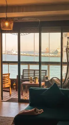 a living room with a view of the ocean at Epic Oceanfront Flat - 360 Sea View in Casablanca