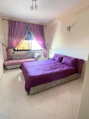 a bedroom with a purple bed and a window at Palace, Appartement Rabat Agdal in Rabat