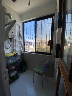 a room with a window and a chair in a room at Palace, Appartement Rabat Agdal in Rabat
