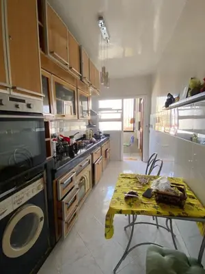 a kitchen with a table in the middle of it at Palace, Appartement Rabat Agdal in Rabat