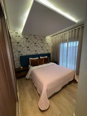 a bedroom with a large bed and a window at Luxury SeaView Apartment 2 Minutes From Beachfront in Rabat