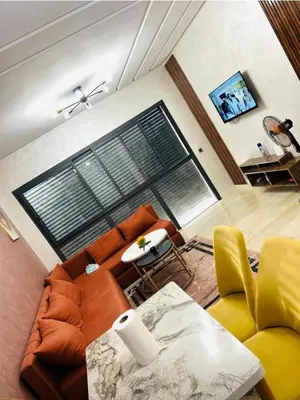 a living room with a couch and a chair at residence cheickno firdaous casablanca in Settat