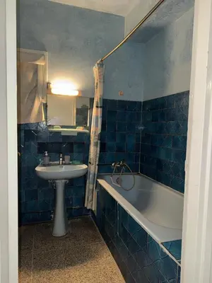 a blue tiled bathroom with a sink and a tub at House for rent in Agdal in Rabat