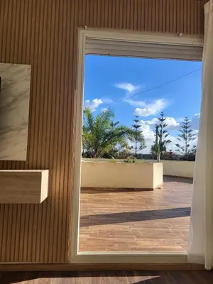 a door to a patio with a view of the ocean at Villa Prestige avec piscine in Tamaris