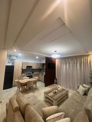 a living room with a couch and a table at Modern fully-equipped apartment in a residence in Pont Blondin