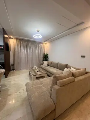 a living room with a couch and a table at Modern fully-equipped apartment in a residence in Pont Blondin