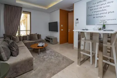 a living room with a couch and a table at Appartement cosy & chic Triangle d'or in Casablanca