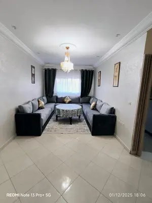 a living room with a couch and a table at Appartement in Mohammedia