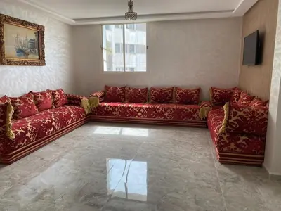 a living room with red couches and a window at pretty apparently in Casablanca