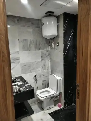 a bathroom with a white toilet and a sink at Apparemment errahma vile in Casablanca