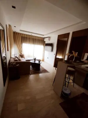 a living room with a couch and a table at New Cozy Studio In the Cornish of Casablanca in Casablanca