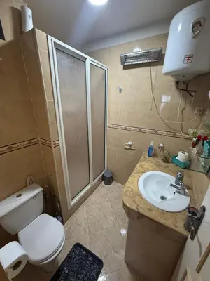 a bathroom with a shower and a toilet and a sink at Appartement à 2 min gare Agdal bien situé in Rabat