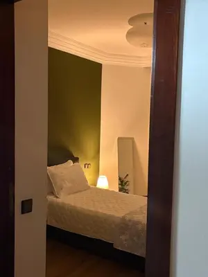 a bedroom with a bed and a mirror at The green stay in Rabat