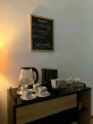 a table with cups and saucers and a chalkboard at The green stay in Rabat