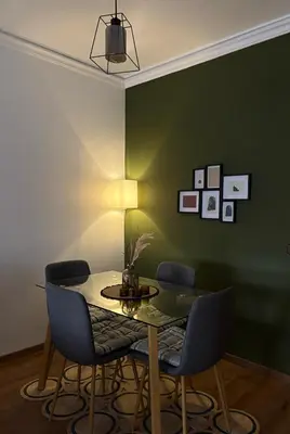 a dining room with a table and blue chairs at The green stay in Rabat